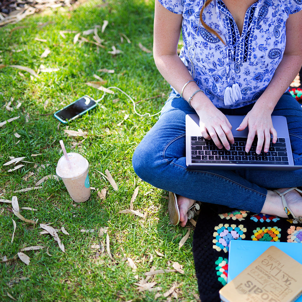 Mel working outdoors on her laptop
